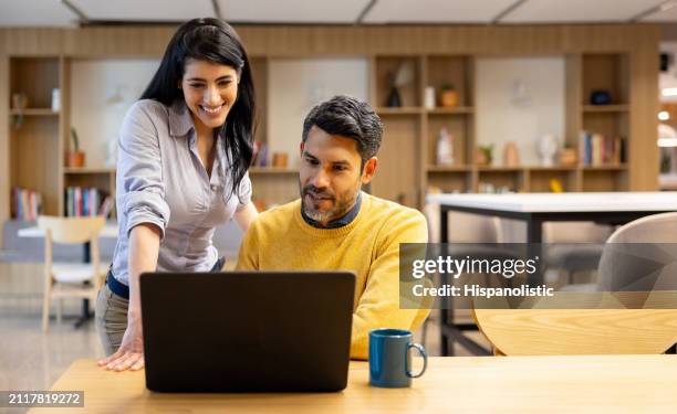 business people working together at the office on a laptop computer - hispanolistic stock pictures, royalty-free photos & images