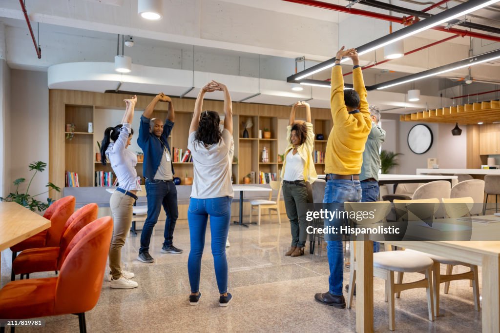 Business people taking an active break at the office and stretching
