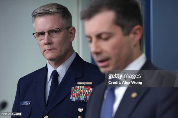 Secretary of Transportation Pete Buttigieg speaks as Deputy Commandant for Operations for the U.S. Coast Guard Vice Admiral Peter Gautier listens...