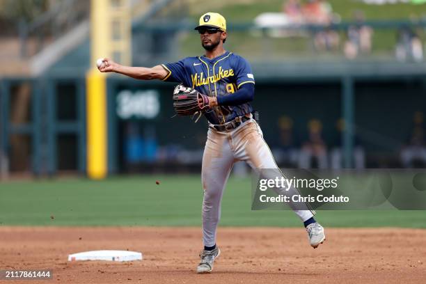 Eric Brown Jr. #91 of the Milwaukee Brewers turns a double play during a spring training game against the Colorado Rockies at Salt River Fields at...