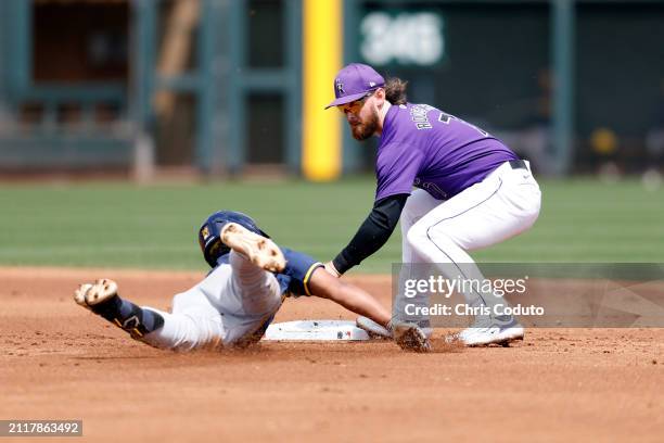 Brendan Rodgers of the Colorado Rockies tags out Eric Brown Jr of the Milwaukee Brewers during the second inning of a spring training game at Salt...