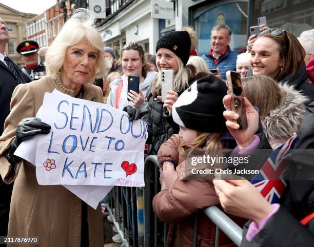 Queen Camilla receives a message of support for Catherine, Princess of Wales from well-wishers during her visit to the Farmers' Market on March 27,...