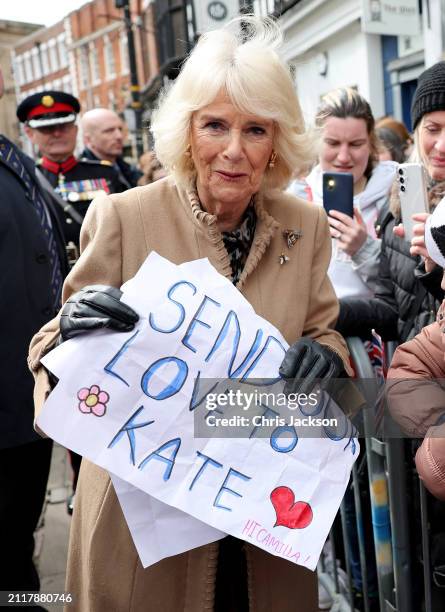 Queen Camilla receives a message of support for Catherine, Princess of Wales from well-wishers during her visit to the Farmers' Market on March 27,...