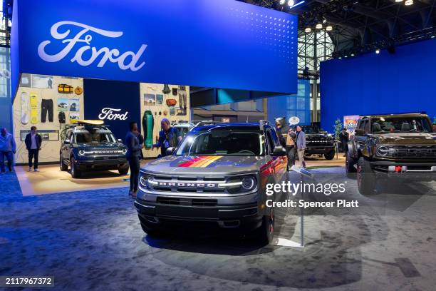 People walk through the Ford exhibit at the New York International Auto Show on March 27, 2024 in New York City. The annual show, which opens to the...