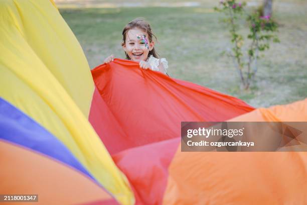 little girl wave big tent made of parachute - parachute stock pictures, royalty-free photos & images