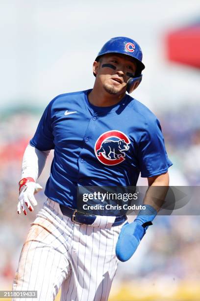 Seiya Suzuki of the Chicago Cubs runs to third base after a hit by Cody Bellinger during the third inning of a spring training game against the St....