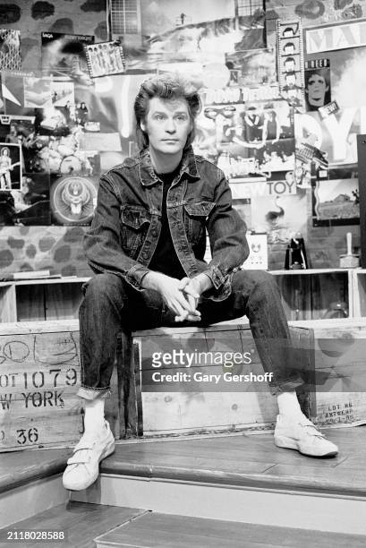 View of American Pop musician Daryl Hall (born Daryl Hohl, of the duo Hall & Oates, as he sits on a low stage during an interview on MTV at...