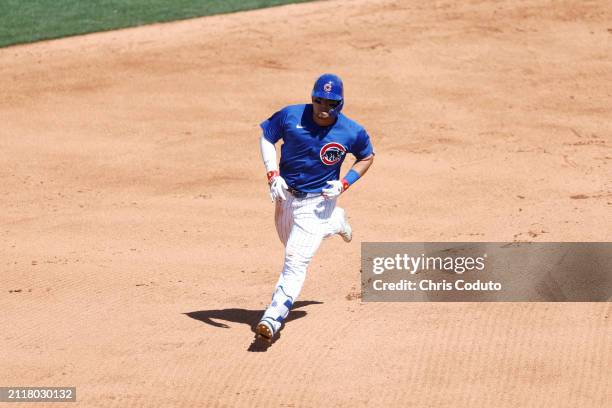 Seiya Suzuki of the Chicago Cubs runs the bases after hitting a solo home run during a spring training game against the St. Louis Cardinals at Sloan...