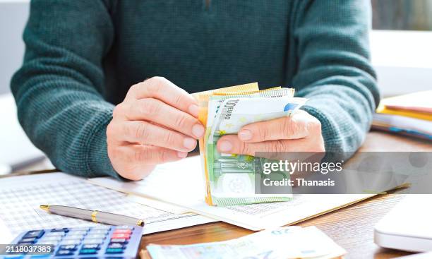 close-up on a person's hand counting money, european currency - euros stockfoto's en -beelden