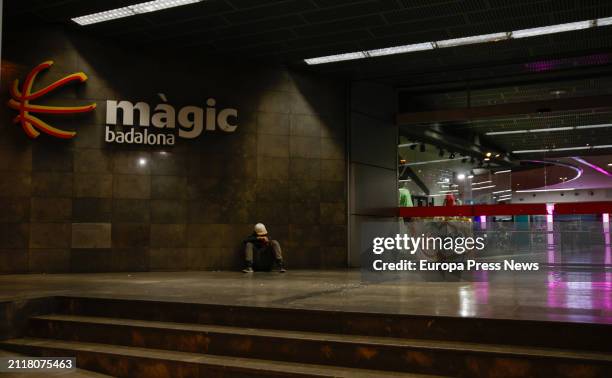 Person sitting at an entrance of the Magic Badalona shopping center, on 27 March, 2024 in Badalona, Catalonia, Spain. A man has been arrested this...