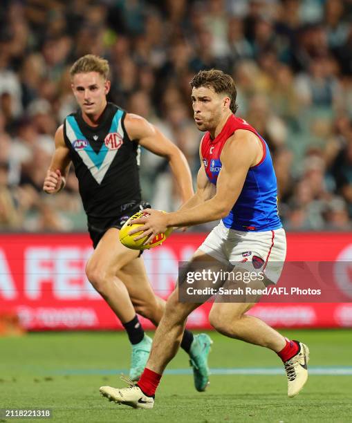 Jack Viney of the Demons and Jackson Mead of the Power during the 2024 AFL Round 03 match between the Port Adelaide Power and the Melbourne Demons at...