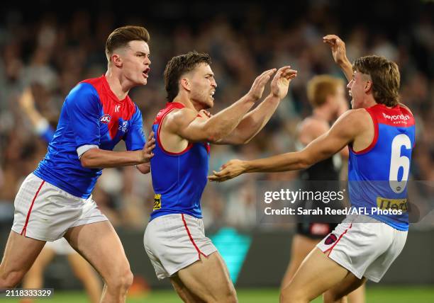 Jack Viney of the Demons celebrates a goal with team mates Caleb Windsor and Bayley Fritsch during the 2024 AFL Round 03 match between the Port...