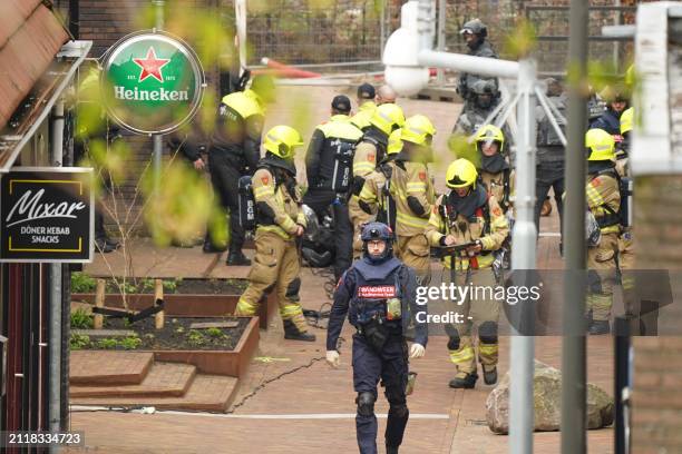 Police and emergency services gather as several people have been taken hostage in Ede, on March 30, 2024. "A hostage situation involving several...