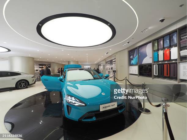Customers are experiencing the SU7 new energy supercar at the Xiaomei Home in Beijing, China, on March 30, 2024.
