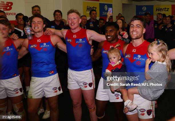 Jack Viney of the Demons sings the song with team mates and his daughters during the 2024 AFL Round 03 match between the Port Adelaide Power and the...