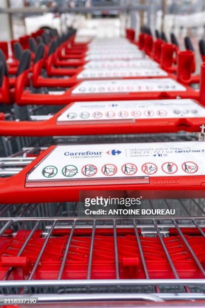 Shopping trolley or cart from the Carrefour Part-Dieu supermarket parked outside, illustrating consumption and purchasing power in Lyon, France on 21...