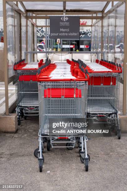 Shopping trolley or cart from the Carrefour Part-Dieu supermarket parked outside, illustrating consumption and purchasing power in Lyon, France on 21...