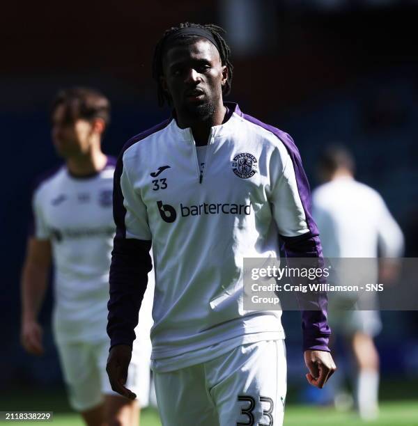 Hibs Rocky Bushiri warms up during a cinch Premiership match between Rangers and Hibernian at Ibrox Stadium, on March 30 in Glasgow, Scotland.