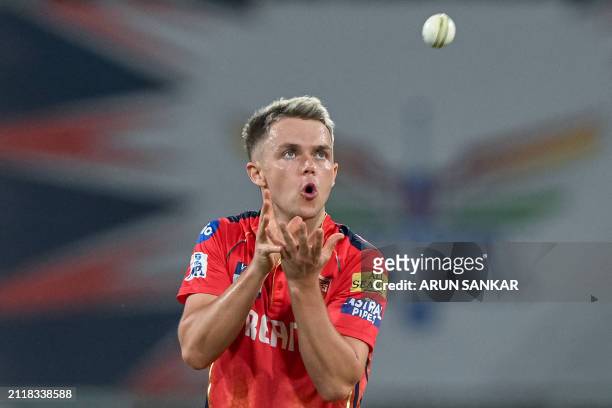Punjab Kings' Sam Curran collects a throw during the Indian Premier League Twenty20 cricket match between Lucknow Super Giants and Punjab Kings at...