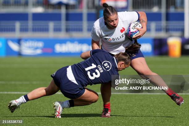 France's prop Assia Khalfaoui is tackled by Scotland's centre Emma Orr during the Six Nations international women's rugby union match between...