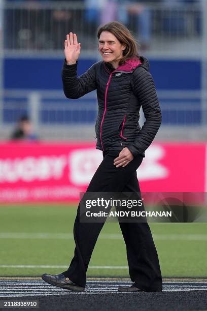 British ultra-runner Jasmin Paris waves as she enters the pitch to hand out the match ball before the Six Nations international women's rugby union...