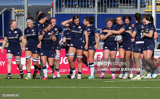 Scotland's players celebrate after scoring a try during the Six Nations international women's rugby union match between Scotland and France at The...