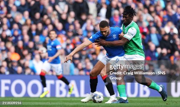 Rangers Cyriel Dessers and Hibs Rocky Bushiri in action during a cinch Premiership match between Rangers and Hibernian at Ibrox Stadium, on March 30...