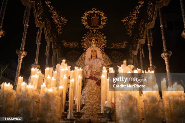 Members of the brotherhood of Nuestra Madre de Dios de las Angustias are participating in the Good Friday procession during Holy Week in Barcelona,...