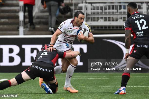 Bordeaux-Begles' French full back Nans Ducuing is tackled by Lyon's French lock Felix Lambey during a French Top 14 rugby union match between Lyon...