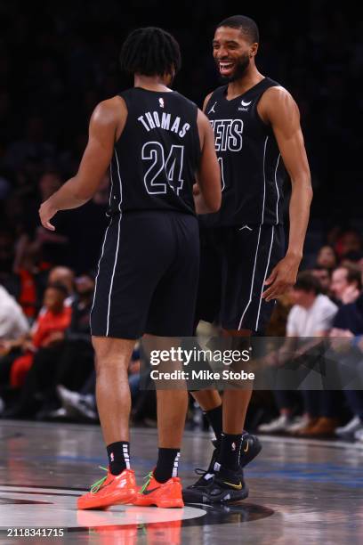 Mikal Bridges of the Brooklyn Nets celebrates with Cam Thomas after making a three point basket against the Chicago Bulls at Barclays Center on March...