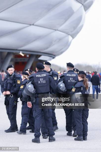Police patrol outside the Allianz Arena as fans arrive prior to the German first division Bundesliga football match FC Bayern Munich v BVB Borussia...
