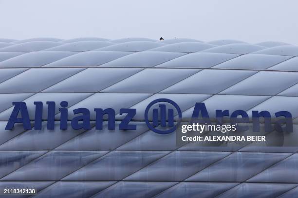 Police offices watches from the roof of the Allianz Arena as fans arrive prior to the German first division Bundesliga football match FC Bayern...