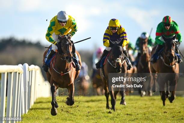 Meath , Ireland - 30 March 2024; Effernock Fizz, left, with Carl Millar up, on their way to winning the RYBO Handicap Hurdle on day one of the...