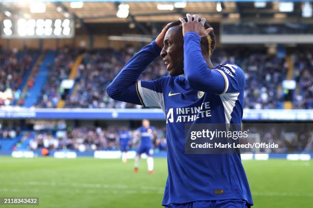 Nicolas Jackson of Chelsea holds his head in his hands during the Premier League match between Chelsea FC and Burnley FC at Stamford Bridge on March...