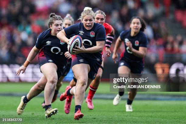 England's hooker Connie Powell runs with the ball during the Six Nations international women's rugby union match between England and Wales at Ashton...