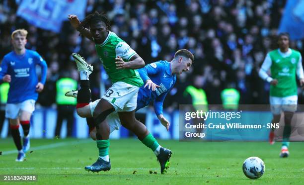 Hibs Rocky Bushiri and Rangers Tom Lawrence in action during a cinch Premiership match between Rangers and Hibernian at Ibrox Stadium, on March 30 in...