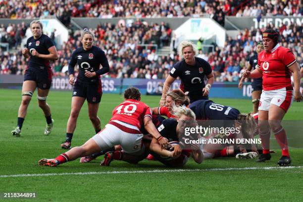 England's lock Rosie Galligan dives across the line to score a try during the Six Nations international women's rugby union match between England and...