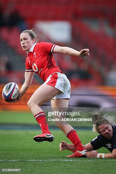 England's flanker Marlie Packer tackles Wales' full-back Jenny Hesketh during the Six Nations international women's rugby union match between England...