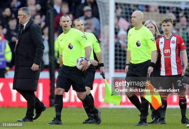 Referee Tim Robinson leads his assistants off the field to a chorus of jeers from the home crowd following the Premier League match between Sheffield...