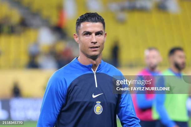 Nassr's Portuguese forward Cristiano Ronaldo warms up ahead of the Saudi Pro League football match between Al-Nassr and Al-Tai in Riyadh's Al-Awal...