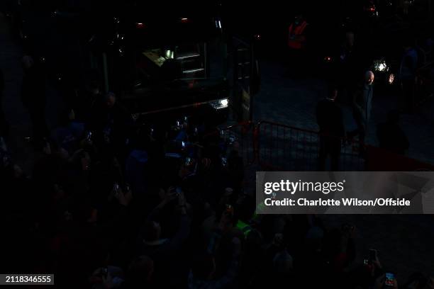 Manchester United manager Erik ten Hag is caught in a shaft of light as he arrives at the stadium ahead of the Premier League match between Brentford...