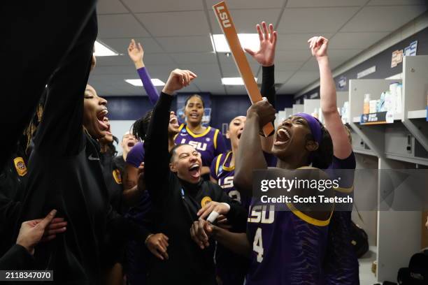 Flau'jae Johnson of the LSU Lady Tigers celebrates with teammates in the locker room after defeating the UCLA Bruins during the Sweet Sixteen round...
