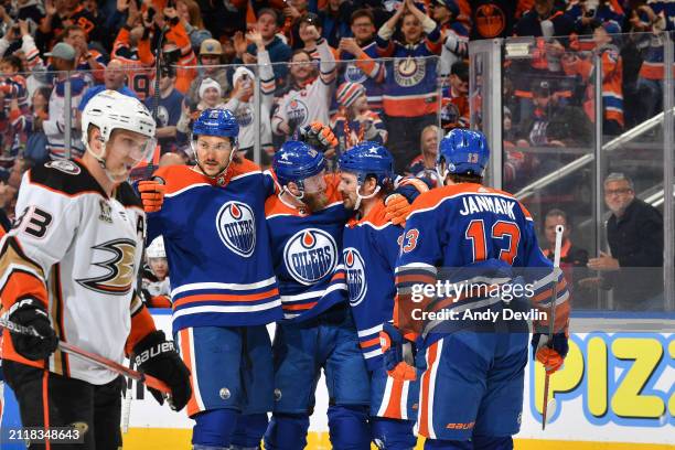 Mattias Ekholm of the Edmonton Oilers celebrates his first-period goal against the Anaheim Ducks with teammates Mattias Janmark, Sam Carrick and...