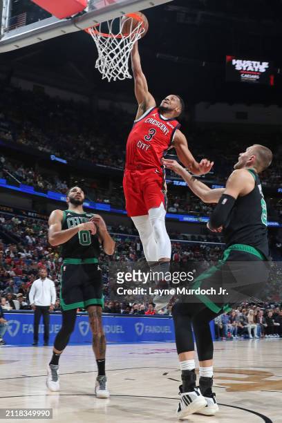 McCollum of the New Orleans Pelicans dunks the ball during the game against the Boston Celtics on March 30, 2024 at the Smoothie King Center in New...