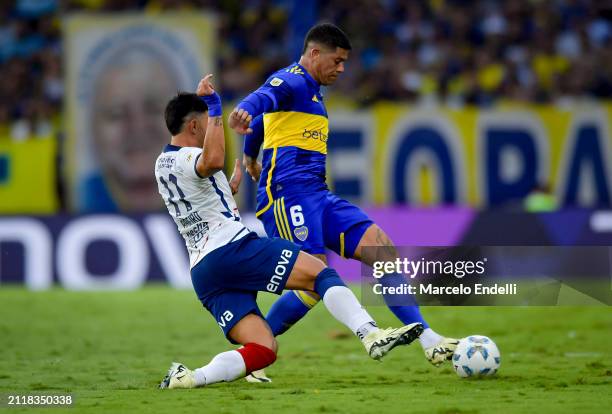 Marcos Rojo of Boca Juniors competes for the ball with Adam Bareiro of San Lorenzo during a group B match between Boca Juniors and San Lorenzo at...