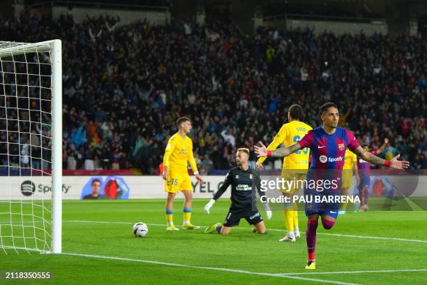 Barcelona's Brazilian forward Raphinha celebrates after scoring his team's first goal during the Spanish league football match between FC Barcelona...