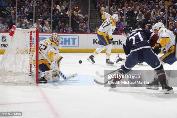 Jonathan Drouin of the Colorado Avalanche tips a puck past goaltender Kevin Lankinen of the Nashville Predators at Ball Arena on March 30, 2024 in...