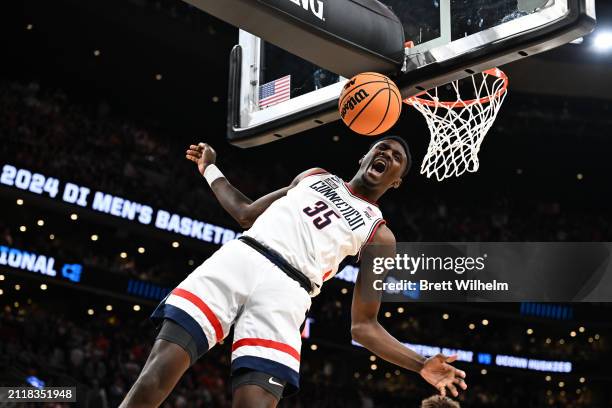 Samson Johnson of the Connecticut Huskies celebrates after a dunk against Illinois Fighting Illini during the first half in the Elite Eight round of...