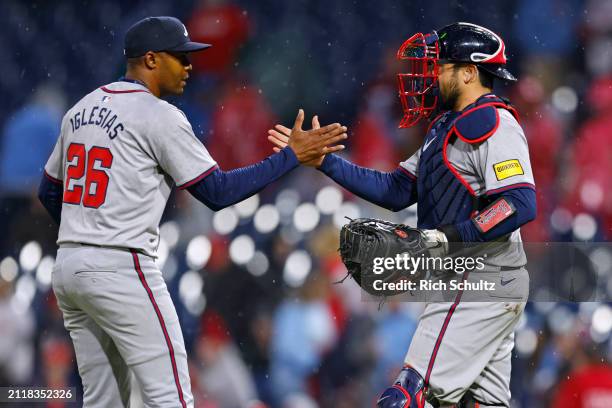 Closer Raisel Iglesias and catcher Travis d'Arnaud of the Atlanta Braves celebrate their 12-4 victory the Philadelphia Phillies in a game at Citizens...