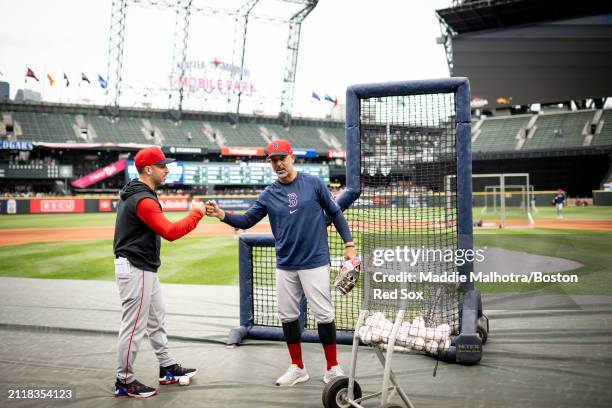 Hitting Coach Peter Fatse of the Boston Red Sox reacts with Manager Alex Cora of the Boston Red Sox during batting practice before a game against the...